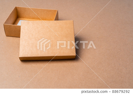 Cardboard box on beige background in studio 88679292