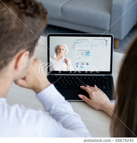Business webinar. Video presentation. Distance education. Students watching senior female coach online marketing lesson on laptop screen at home. 88679293