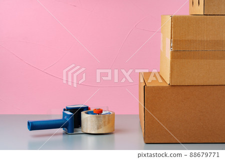 Set of cardboard boxes on pink background Set of cardboard boxes on pink background 88679771