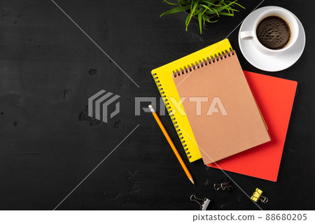 Three notepads on a black table close up Three notepads on a black table close up 88680205