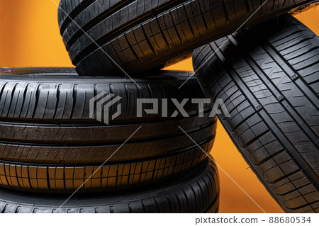 Car tires isolated on yellow background, close up 88680534