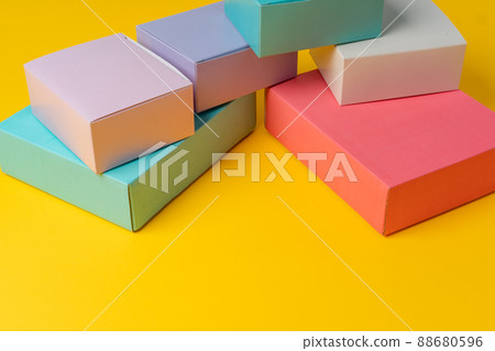 Colorful cardboard boxes on yellow background, copy space Colorful cardboard boxes on yellow background, copy space 88680596