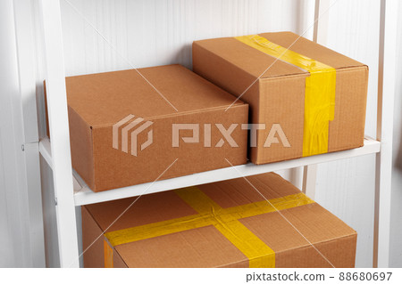 Stack of cardboard package boxes on wooden rack Stack of cardboard package boxes on wooden rack 88680697