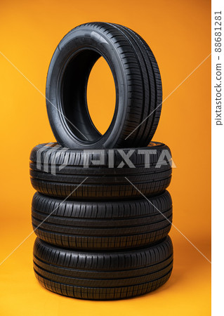 Car tires isolated on yellow background, close up 88681281