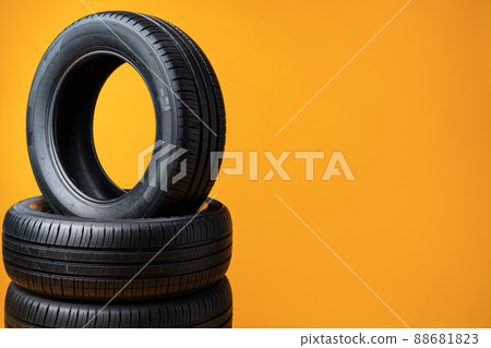 Car tires isolated on yellow background, close up Car tires isolated on yellow background, close up 88681823