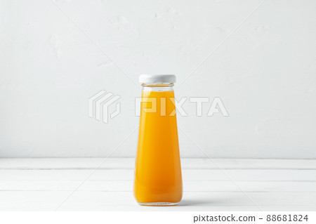 Small glass bottle of fresh juice on white background Small glass bottle of fresh juice on white background 88681824