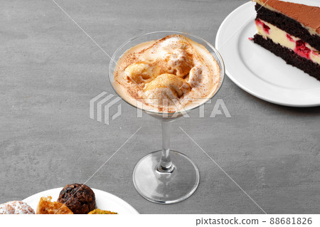 Coffee cup and sweet candy on gray table Coffee cup and sweet candy on gray table 88681826