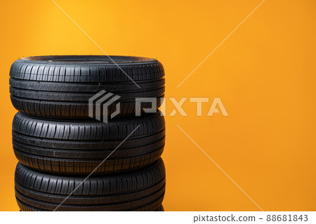 Car tires isolated on yellow background, close up Car tires isolated on yellow background, close up 88681843