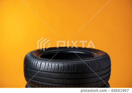 Car tires isolated on yellow background, close up 88681967