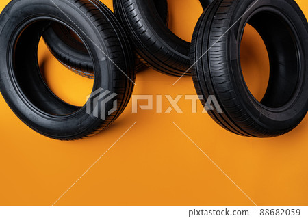Car tires isolated on yellow background, close up Car tires isolated on yellow background, close up 88682059