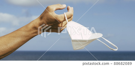 has his FFP2 face mask in his hand, banner format 88682089