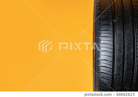 Car tires isolated on yellow background, close up Car tires isolated on yellow background, close up 88682623