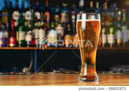 Fresh cold beer in glass on bar background 88682875