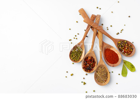 Colorful spices in the wooden spoons on white background. 88683030