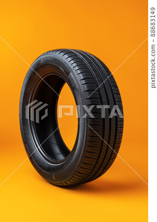 Car tires isolated on yellow background, close up 88683149