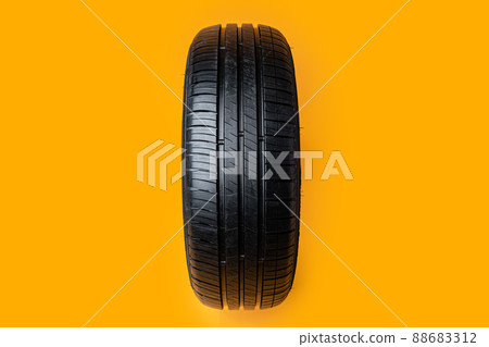 Car tires isolated on yellow background, close up Car tires isolated on yellow background, close up 88683312