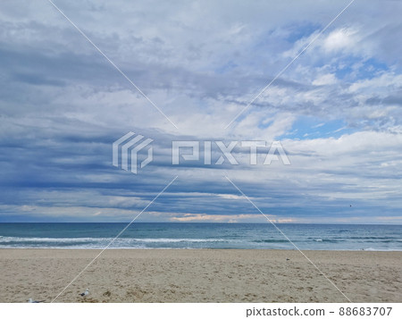 Calm and serene quiet sandy beach in the tranquil afternoon near the sea Calm and serene quiet sandy beach in the tranquil afternoon near the sea 88683707