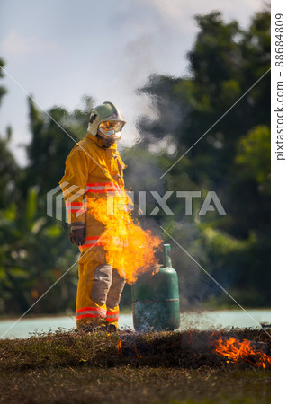 Firefighter with fire and suit for protect fire fighter for training firefighters. 88684809