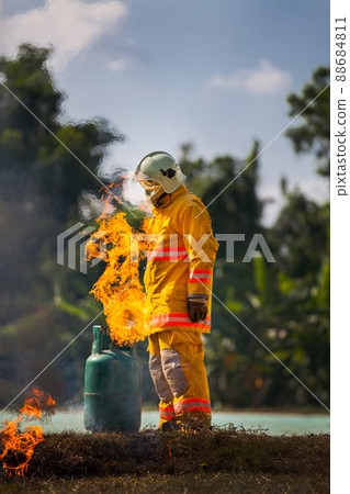 Firefighter with fire and suit for protect fire fighter for training firefighters. Firefighter with fire and suit for protect fire fighter for training firefighters. 88684811