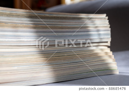 A stack of magazines against a gray background. Close-up of old print editions. A stack of magazines against a gray background. Close-up of old print editions. 88685476