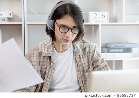 Male student is doing homework given by the teacher through the laptop's live performance system, My homework, Using laptops and data graphs in class, Online communication, Social distancing. Male student is doing homework given by the teacher through the laptop's live performance system, My homework, Using laptops and data graphs in class, Online communication, Social distancing. 88685737