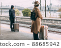 People waiting at the train platform 88685942