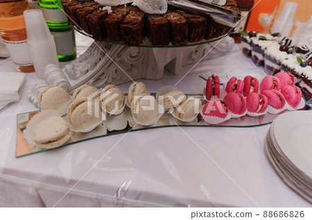 Sweet cakes at a wedding banquet. Catering, sweet festive buffet. Candy bar Sweet cakes at a wedding banquet. Catering, sweet festive buffet. Candy bar 88686826