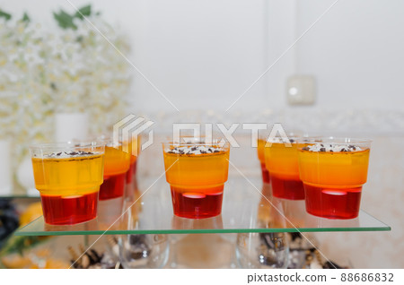 Sweet cakes at a wedding banquet. Catering, sweet festive buffet. Candy bar 88686832