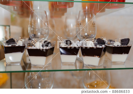 Sweet cakes at a wedding banquet. Catering, sweet festive buffet. Candy bar 88686833