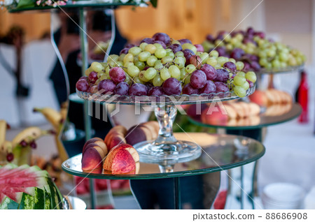 Fruit slicing at the wedding buffet Fruit slicing at the wedding buffet 88686908