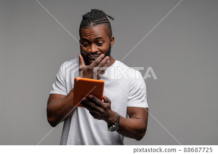 Surprised pleased man watching a TV show on the Internet 88687725