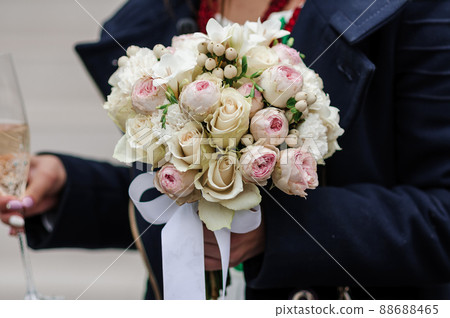Bouquet of flowers in the groom's hand Bouquet of flowers in the groom's hand 88688465
