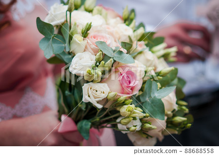 Bouquet of flowers in the hand of the bride Bouquet of flowers in the hand of the bride 88688558