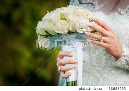 Bouquet of flowers in the hand of the bride Bouquet of flowers in the hand of the bride 88688563