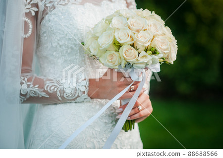 Bouquet of flowers in the hand of the bride Bouquet of flowers in the hand of the bride 88688566