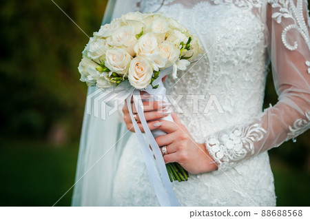 Bouquet of flowers in the hand of the bride Bouquet of flowers in the hand of the bride 88688568