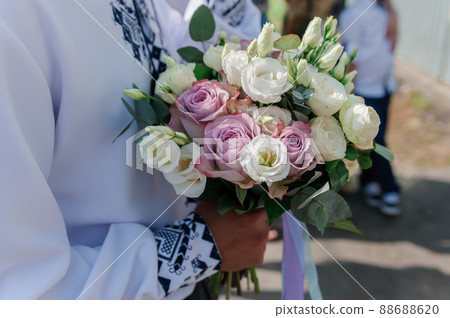 Bouquet of flowers in the groom's hand 88688620
