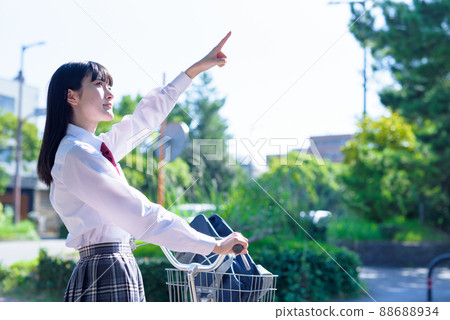 A high school girl who goes to school by bicycle, pointing her finger up at the sky, a residential area, a beautiful fresh green A high school girl who goes to school by bicycle, pointing her finger up at the sky, a residential area, a beautiful fresh green 88688934