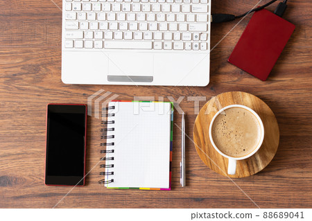 Workspace with laptop, diary and a cup of coffee on wooden background. Stylish office workplace. 88689041