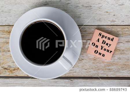 Motivational quote on notepad with white coffee cup on wooden desk. 88689743