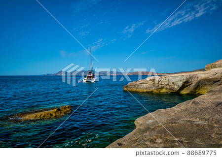 Yacht boat at Sarakiniko Beach in Aegean sea, Milos island , Greece Yacht boat at Sarakiniko Beach in Aegean sea, Milos island , Greece 88689775