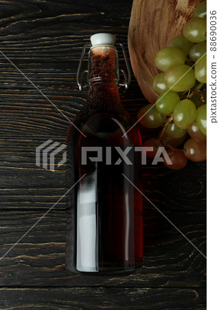 Bottle of vinegar and grape on rustic wooden table 88690036