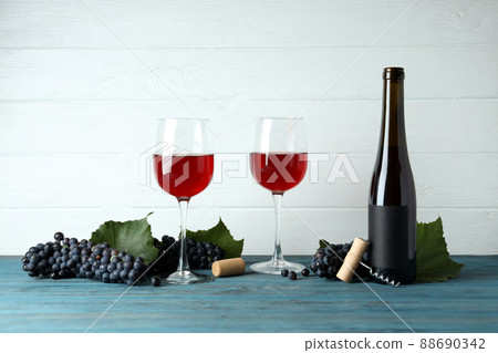 Red wine, grape, cork and corkscrew on wooden table Red wine, grape, cork and corkscrew on wooden table 88690342