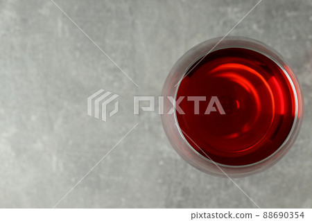Glass of red wine on gray textured background 88690354