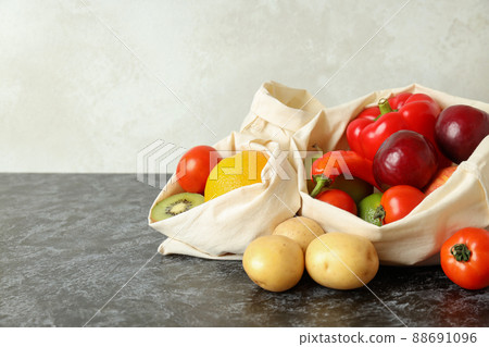 Bags with vegetables and fruits on black smokey table 88691096
