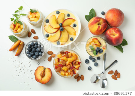 Concept of healthy food with peach yogurt and ingredients on white background 88691177