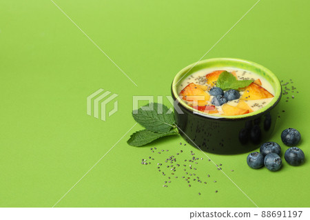 Concept of healthy food with peach yogurt on green background 88691197