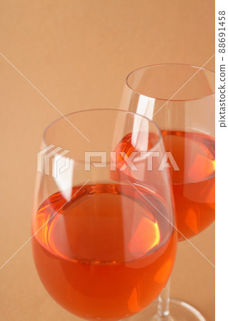 Glasses of wine on beige background, close up 88691458