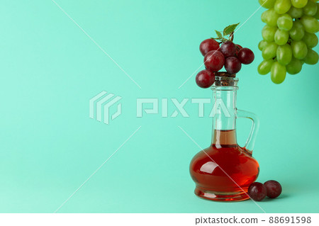 Bottle of vinegar and grape on mint background 88691598