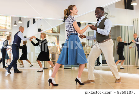Pair dancing lindy hop during rehearsal Pair dancing lindy hop during rehearsal 88691873